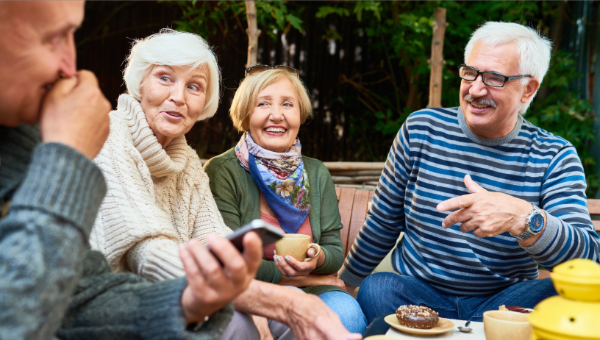 four older adults sitting around the table