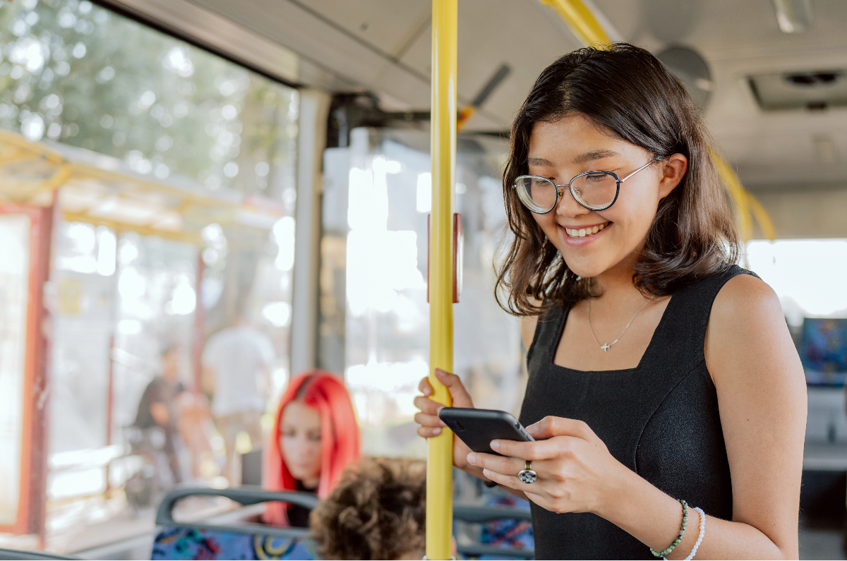 Woman using phone on the bus